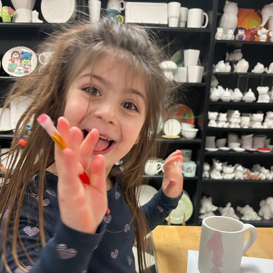 Kids enjoying creative pottery painting at Sunshine Pottery Englewood NJ art classes in a welcoming local studio environment.